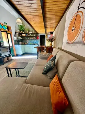 a room with a staircase and a table and chairs at Casa Flor do Monte in Funchal