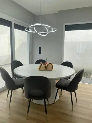 a dining room with a white table and chairs at Sun Temple by Madeira Holiday Rentals in Ribeira Brava
