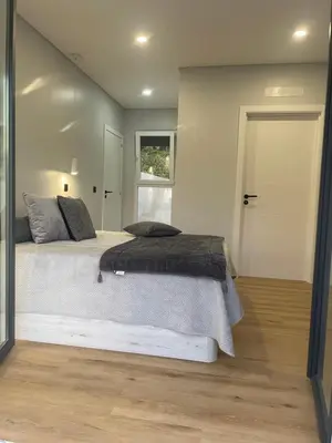 a bedroom with a large bed and a window at Sun Temple by Madeira Holiday Rentals in Ribeira Brava