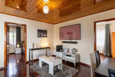 a living room with a table and a tv at GuestReady - Restful Getaway in Madeira in Estreito da Calheta