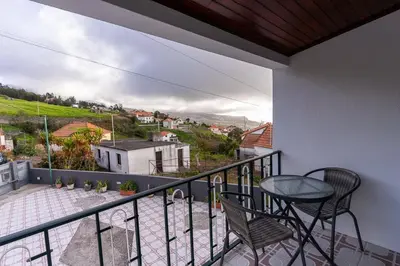 a balcony with a table and chairs and a view at GuestReady - Restful Getaway in Madeira in Estreito da Calheta