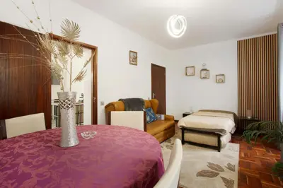 a living room with a table and a bedroom at Carros De Cesto Do Monte in Funchal
