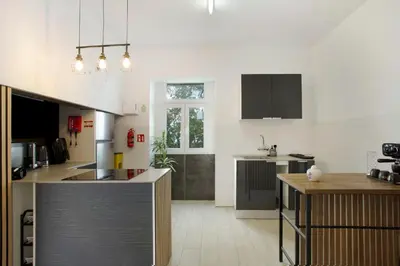 a kitchen with a table and a counter top at Carros De Cesto Do Monte in Funchal