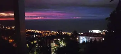 a view of a city at night at Carros De Cesto Do Monte in Funchal