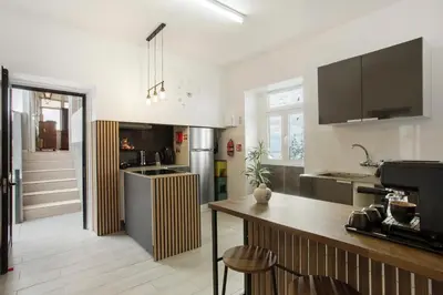 a kitchen with a counter and a clock on the wall at Carros De Cesto Do Monte in Funchal