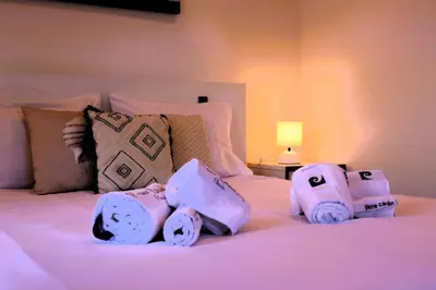 a bed with a pile of towels on it at Casa Tio Albino I, By OP in Ponta Delgada
