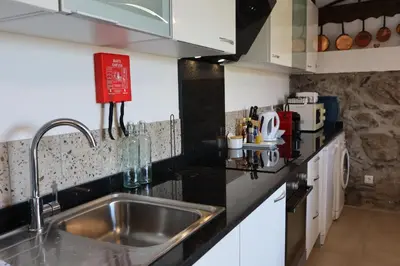a kitchen with a sink and a counter top at Casa do Tio Albino II, By OP in Ponta Delgada