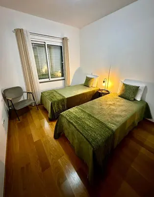 a hotel room with two beds and a window at Reis Magos Ocean View in Caniço