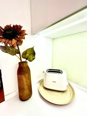 a toaster sitting on a counter next to a vase at Reis Magos Ocean View in Caniço