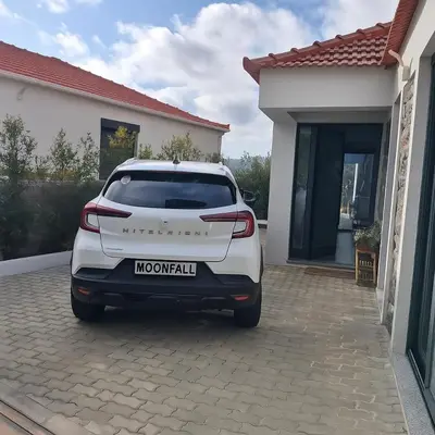 a white car parked in front of a house at Moonfall House in Arco da Calheta