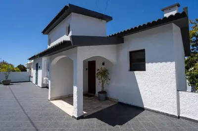 a white house with a potted plant in front of it at Villa Ocean Bay Funchal By Empório in Funchal