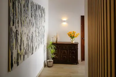 a hallway with a vase of flowers and a painting on the wall at Villa Ocean Bay Funchal By Empório in Funchal