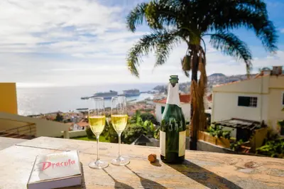 two glasses of white wine sitting on a table at Villa Ocean Bay Funchal By Empório in Funchal