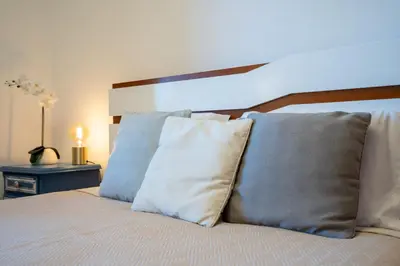 a bedroom with a bed with two pillows on it at Villa Ocean Bay Funchal By Empório in Funchal