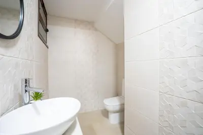 a white bathroom with a toilet and a sink at Villa Ocean Bay Funchal By Empório in Funchal