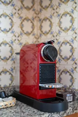 a red toaster oven sitting on top of a counter at Villa Ocean Bay Funchal By Empório in Funchal