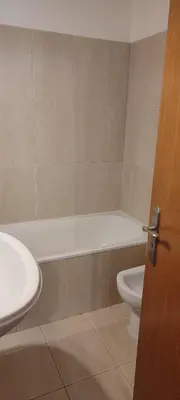 a bathroom with a tub and a toilet and a sink at Marina Kings View in Funchal