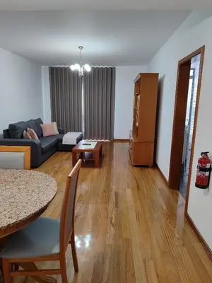 a living room with a couch and a table at Marina Kings View in Funchal