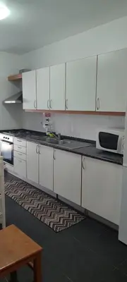 a kitchen with white cabinets and a counter top at Marina Kings View in Funchal