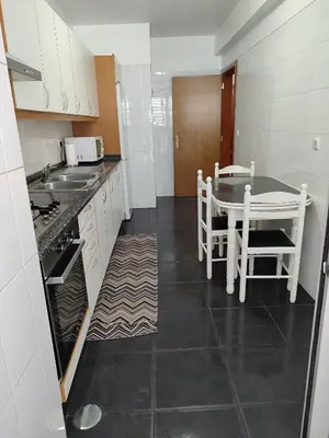 a kitchen with a table and a table and chairs at Marina Kings View in Funchal