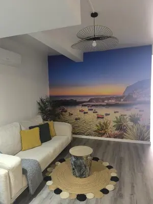 a living room with a couch and a rug at Cris Place in Câmara de Lobos