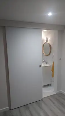 a towel rack in a shower with yellow towels at Cris Place in Câmara de Lobos