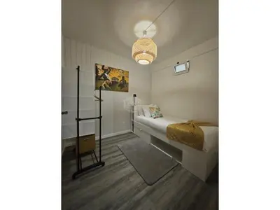 a bedroom with a bed with a blanket on it at Cris Place in Câmara de Lobos