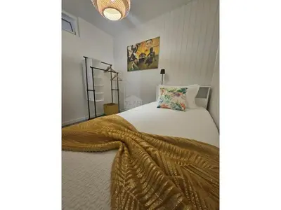 a bedroom with a bed with a blanket on it at Cris Place in Câmara de Lobos