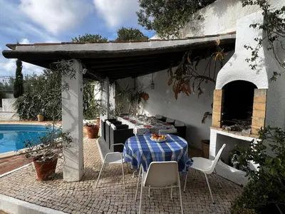 a table with a blue and white checkered table cloth at Casa AncoraDouro in Lagos