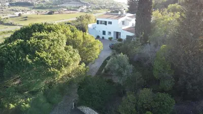 an aerial view of a white house with trees at Casa AncoraDouro in Lagos