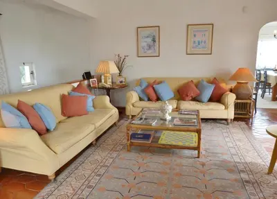 a living room with two couches and a coffee table at Casa AncoraDouro in Lagos