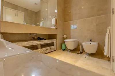 a bathroom with a sink and a toilet and a mirror at GuestReady - Relax in Style in Funchal in Funchal
