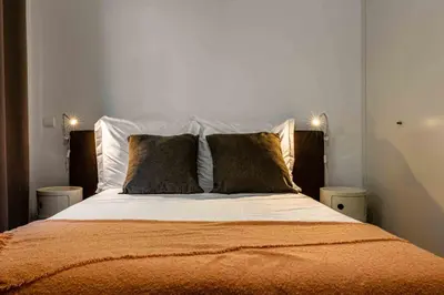 a bedroom with a large bed with two pillows at GuestReady - Relax in Style in Funchal in Funchal