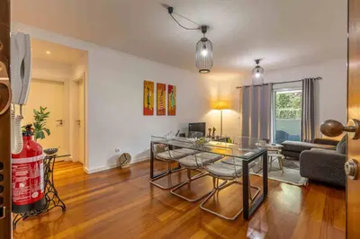 a living room with a glass table and a couch at GuestReady - Relax in Style in Funchal in Funchal