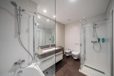 a bathroom with a shower and a sink and a toilet at OurMadeira - Palace Ocean View in Funchal