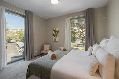 a bedroom with a large bed and a large window at OurMadeira - Palace Ocean View in Funchal