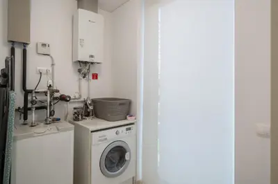 a laundry room with a washing machine and a washer at OurMadeira - Palace Ocean View in Funchal
