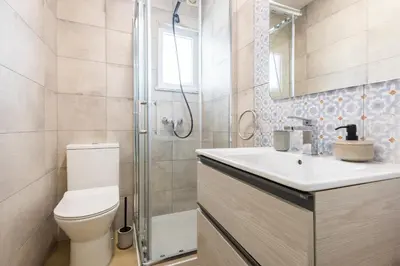 a bathroom with a toilet and a sink and a shower at CASA Castelejo in Vila do Bispo