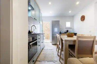 a kitchen with a table and a dining room at CASA Castelejo in Vila do Bispo
