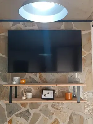 a large flat screen tv hanging from a wall at Kings B&B Eiras in Caniço