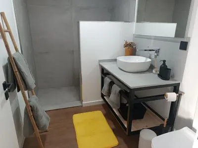 a bathroom with a sink and a shower at Kings B&B Eiras in Caniço