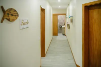 a hallway with a long corridor with a door and a hallway at Casa do Remo in Caniçal