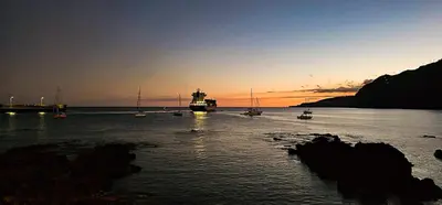 a group of boats in the water at sunset at Casa do Remo in Caniçal