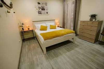 a bedroom with a bed with yellow sheets and two lamps at Casa do Remo in Caniçal