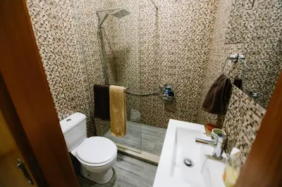 a bathroom with a toilet and a sink and a shower at Casa do Remo in Caniçal