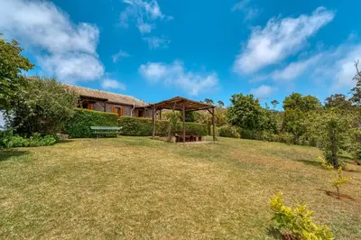 a garden with a pavilion in front of a house at Casa Levada dos Prazeres by Stay in Prazeres