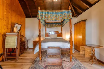 a bedroom with a canopy bed and a wooden ceiling at Casa Levada dos Prazeres by Stay in Prazeres