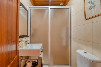 a bathroom with a shower with a sink and a toilet at Casa Levada dos Prazeres by Stay in Prazeres