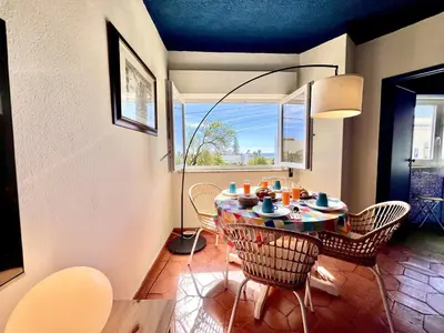 a dining room with a table and chairs and a window at Lagos Ocean Breeze 2 by Homing in Lagos