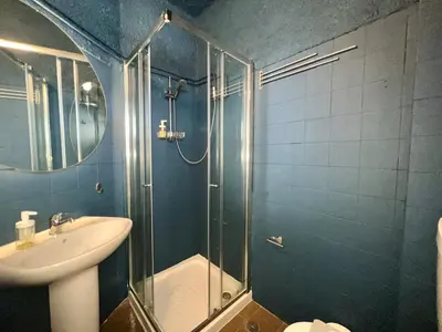 a bathroom with a glass shower and a sink at Lagos Ocean Breeze 2 by Homing in Lagos